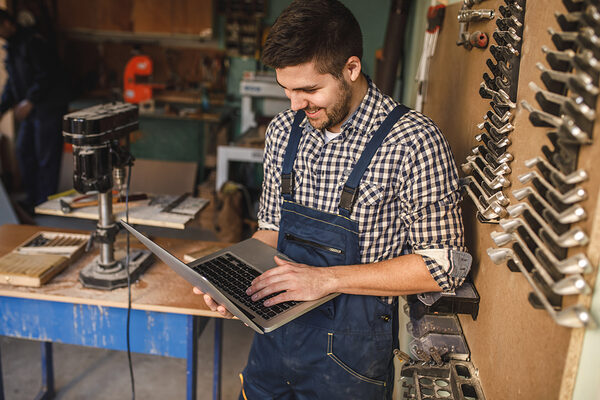 Young carpenter working on a laptop in his workshop. Schlagwort(e): workshop, carpentry, occupation, carpenter, laptop, professional, craftsman, handyman, industry, craft, job, timber, lumber, woodwork, handmade, tools, old, business, manual, worker, plan, expertise, computer, pursuit, art, person, careers, equipment, activity, craftsmanship, talent, decoration, lifestyle, wooden, classic, handicraft, design, skill, capability, career, style, networking, working, woodworker, online, using, smiling, workman, indoors, workshop, carpentry, occupation, carpenter, laptop, professional, craftsman, handyman, industry, craft, job, timber, lumber, woodwork, handmade, tools, old, business, manual, worker, plan, expertise, computer, pursuit, art, person, careers, equipment, activity, craftsmanship, talent, decoration, lifestyle, wooden, classic, handicraft, design, skill, capability, career, style, networking, working, woodworker, online, using, smiling, workman, indoors