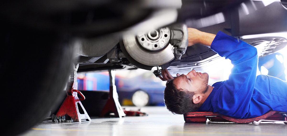 A car mechanic working on the underside of a car Schlagwort(e): Service, Male Beauty, Tighten, One Man Only, Only Men, Men, Male, Copy Space, Adults Only, Auto Mechanic, Job, Jumpsuit, Coveralls, Maintenance Engineer, Repairman, Overalls, Mechanic, 30s, Mid Adult, Adult, Lying Down, Looking, Adjusting, Holding, Repairing, Working, Caucasian, One Person, Wheel, Expertise, Concentration, Low Section, Part Of, Below, Industry, Transportation, Indoors, Manual Worker, Professional Occupation, Occupation, People, Workshop, Auto Repair Shop, Spanner, Work Tool, Equipment, Uniform, Car, Land Vehicle, Attractive Male, Wheel Well