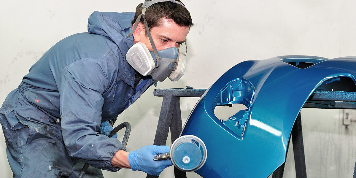 Proffesional car body repair, Painting blue bumper. Schlagwort(e): car painting, painting, airbrush, car, coat, color, crash, door, gun, lacquer, paintbox, professional, front, blue, repair, smart, spot, spray, fender, varnish, mask, masking, box, vehicle, work, body, compressor, bodywork, body, work, cover, garage, paintwork, paper, tape, service, worker, man, painter, booth, mechanic, silver, blue, blue bumper
