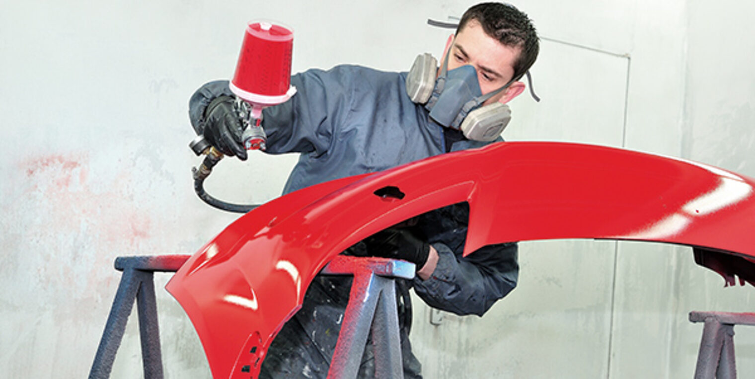 Professional body shop worker painting red ca bumper. Schlagwort(e): car painting, painting, airbrush, car, red, painting red bumper, coat, color, crash, door, gun, lacquer, paintbox, professional, front, blue, repair, smart, spot, spray, fender, varnish, mask, masking, box, vehicle, work, body, compressor, bodywork, body, work, cover, garage, paintwork, paper, tape, service, worker, man, painter, booth, mechanic, blue, bidy shop